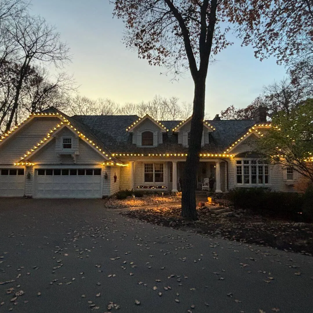 Snow-covered Minnesota rooftop outlined in evenly spaced warm-white lights